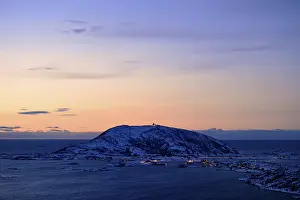 Fjord with mountains in winter at sunset