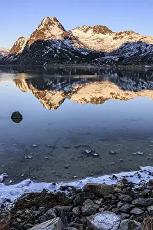 Fjord with steep snowy mountains
