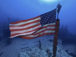 US flag waving in the current on the wreck of the USS Spiegel Grove
