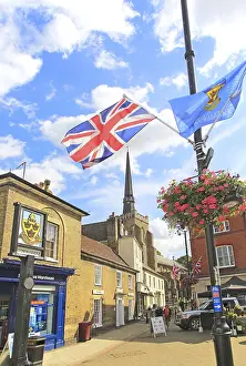 Flags frame view of spire St Peter and St Mary church in town centre