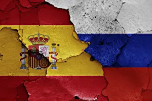 Flags of Spain and Russia painted on cracked wall