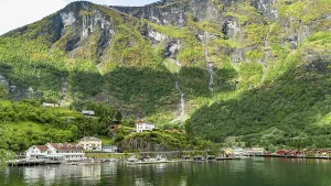 Flam village nestled beneath towering mountains on the Norwegian fjord