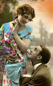 Flirt, man kneels in front of a woman
