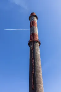 Flue, chimney and vapour trail from aircraft
