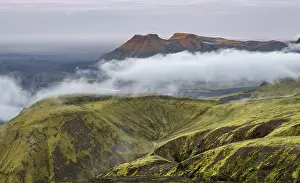 Fog between mountains, moss-covered volcanic mountain landscape