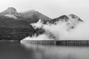 Fog rises over the dam of the Lac de Moiry reservoir