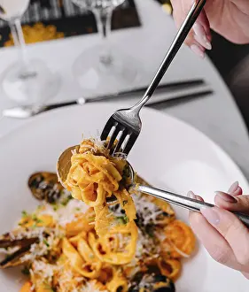 Food, Close-up of a person twirling fork with seafood pasta in a fine dining setting