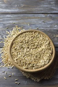 Food, Close-up of raw oat grains in a wooden bowl placed on burlap fabric