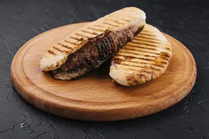 food still-life, Fried pita with pork steak on wooden tray