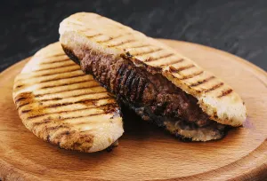 food still-life, Fried pita with pork steak on wooden tray