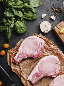 food still-life, Several raw pork steaks on baking paper