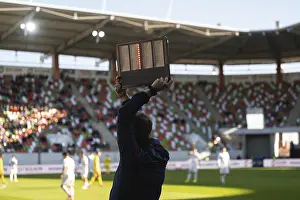 Football sideline referee shows aded time on a electronic board during the game at the stadium in Poland