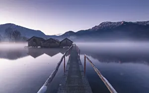 Framed Print : A footbridge leads to three huts in fog