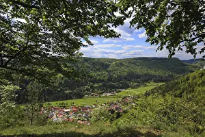 Forest trail to Paterfelsen viewpoint with views of a green valley and wooded hills