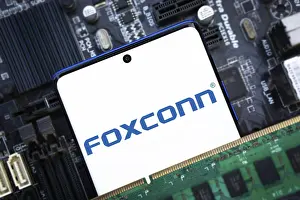 Category Historic EN Prints: Foxconn company Logo on Smartphone
