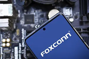 Category Historic EN Prints: Foxconn company Logo on Smartphone