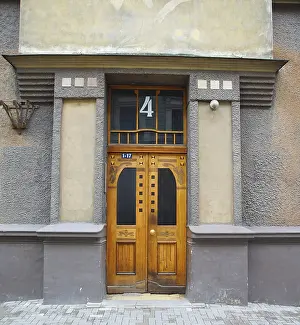 Fragment of the facade with the door of a residential building in the style of national romanticism on one of