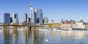 Frankfurt skyline skyscrapers with banks on the river Main with excursion boats and Eiserner Steg panorama in Frankfurt