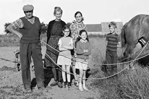 French farmer family with horse in the field