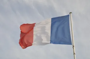 French flag on cloudy sky