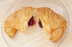 Fresh baked croissant French brioche filled with berries jam