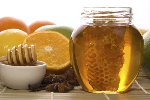 Fresh honey with honeycomb, lemons