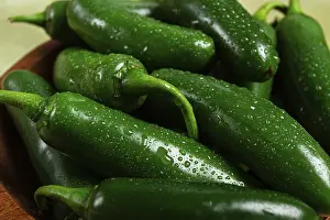 Fresh padron pepper, raw, in a wooden bowl
