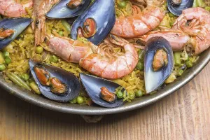 Freshly cooked seafood paella with vibrant colors served in a rustic pan