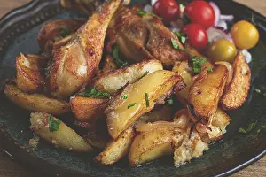 Fried chicken legs with potato slices