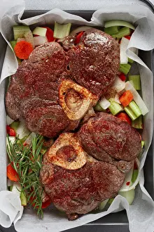 Fried meat on the bone, raw, chopped vegetables