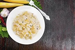 Fried pumpkin with garlic, spices and herbs in a sour cream sauce in a plate