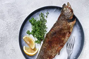 Fried rainbow trout, with herbs and citrus fruits
