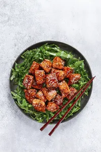 Fried salmon slices, teriyaki with sesame seeds