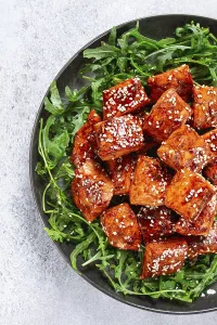 Fried salmon slices, teriyaki with sesame seeds