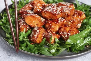Fried salmon slices, teriyaki with sesame seeds