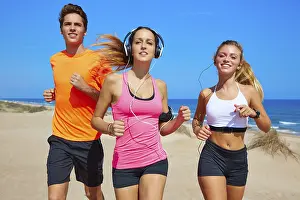 Friends running on the beach happy in summer sunny day
