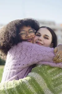 Two friends share a heartfelt hug