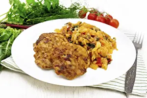 Fritters of minced meat with stewed cabbage in a plate