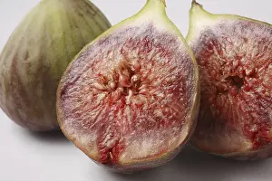 Category Historic EN Prints: Fruit, Figs Ficus Carica Anjir one full and other cut in two half red juicy texture on white background