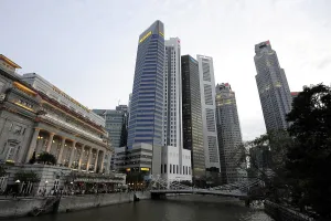 The Fullerton Hotel on Singapore River with Skyscrapers of the Financial District