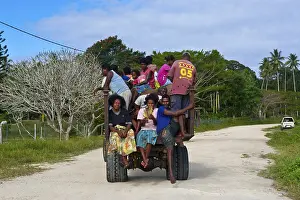 Fully loaded tractor transporting field workers