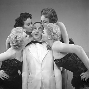 Fun in the 1950s. A group of women is paying much attention to the man in the middle. A group of people from the theatre are fooling around when rehersing. He is actor Ake Soederblom, 1910-1965. Sweden 1955. Photo Kristoffersson Ref BR116-12