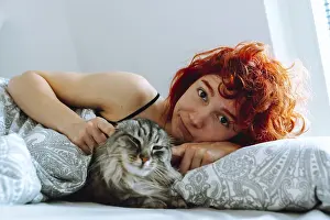 Funny red-haired teenage girl, in morning in bed