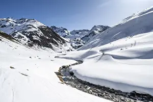Funtauna Valley with mountain stream and snow in winter