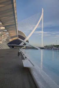 Futuristic architectural design in Valencia next to a water basin under a blue sky City of Arts and Sciences