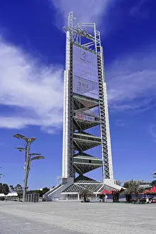 Framed Print : Futuristic tower stands imposing under clear blue sky in urban surroundings Framed Print : Futuristic tower stands imposing under clear blue sky in urban surroundings