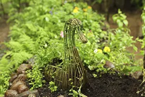 Garden bed with decorative figure of a goose