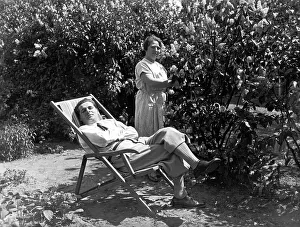 Garden, relaxing in deck chair, ca