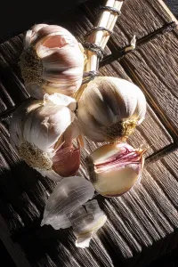 Garlic bulbs on a wooden plate