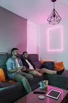 A gay couple relaxes on a sofa